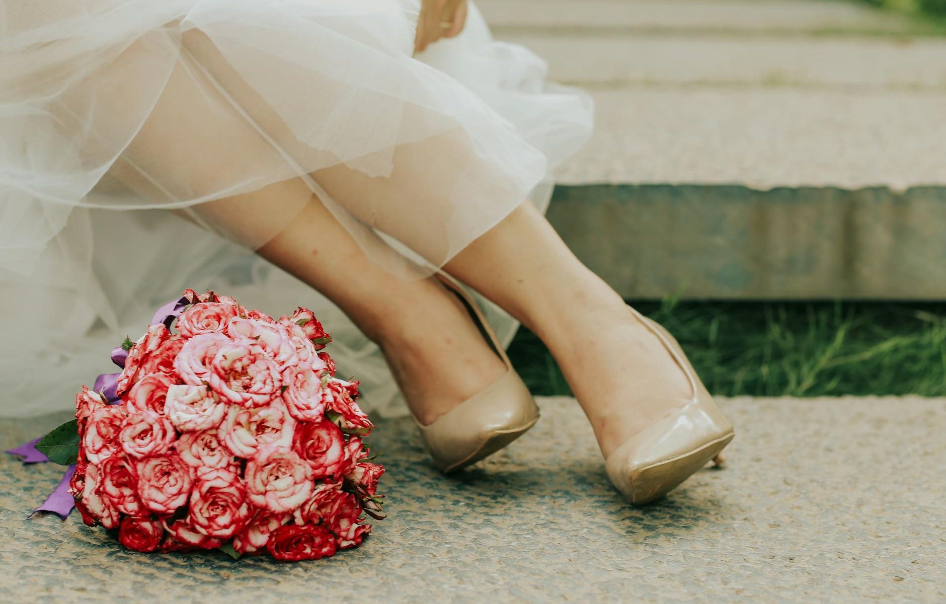 a woman wearing beige wedding shoes