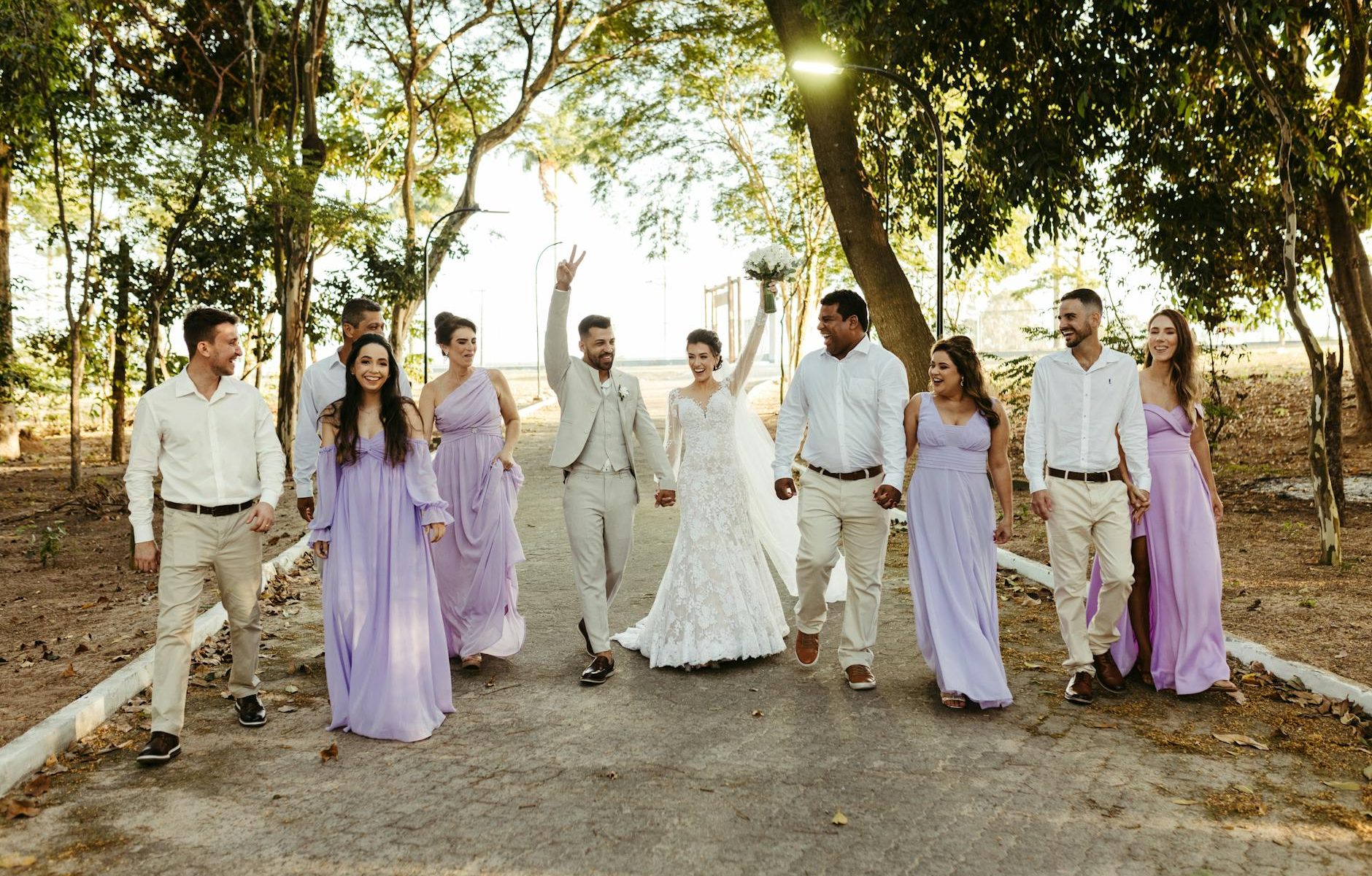 a group of people in white dresses walking down a path